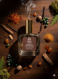 Formula Haus Silent Dividend perfume bottle surrounded by various spices, herbs, and berries on a wooden surface