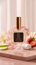 Perfume bottle labeled 'Pink Legacy' with strawberries and flowers on a light background