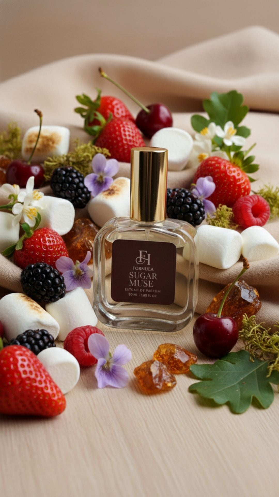 Sugar Muse perfume bottle surrounded by strawberries, blackberries, and marshmallows on a wooden surface.